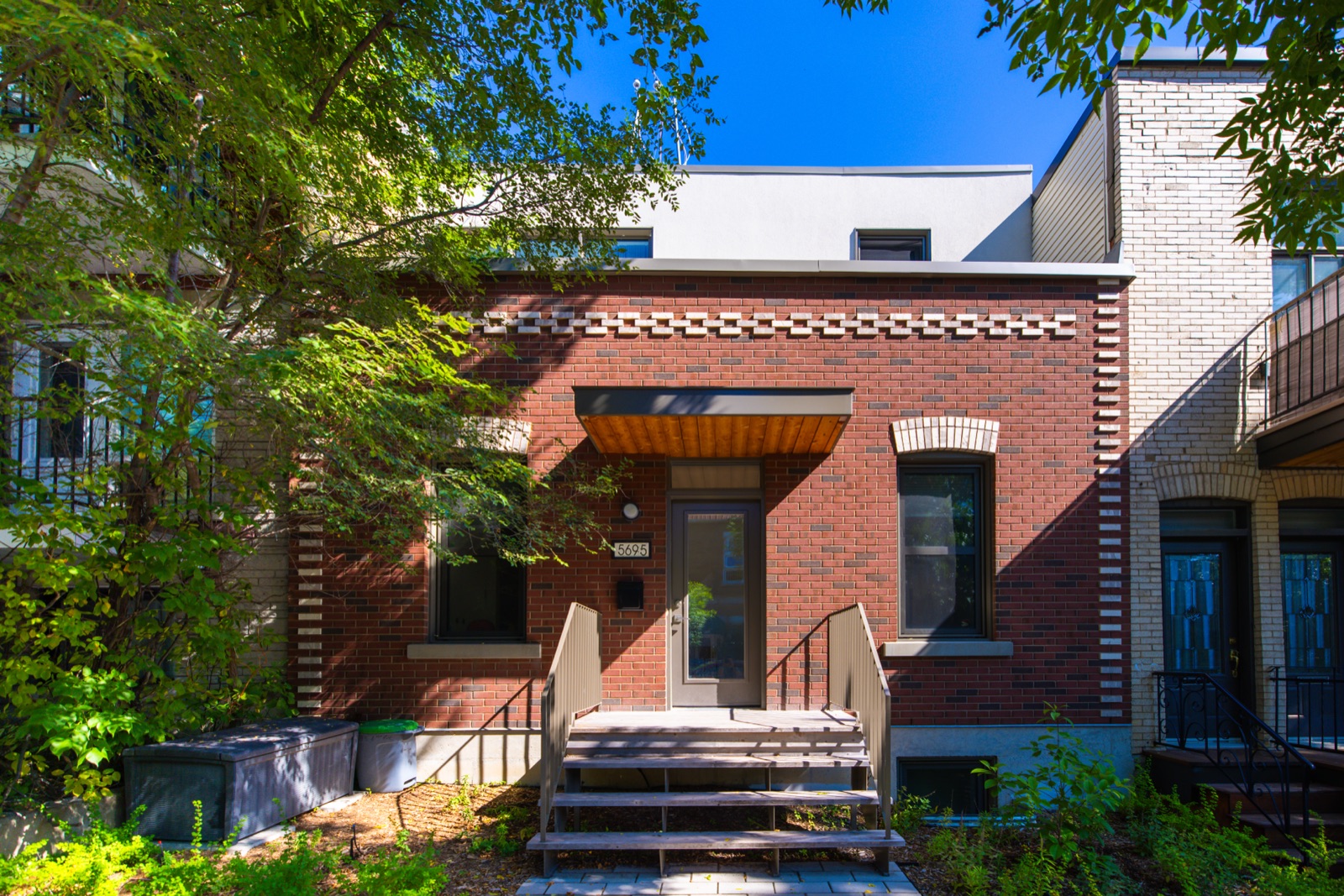 Maison shoebox de brique rouge avec entrée en bois — Rosemont